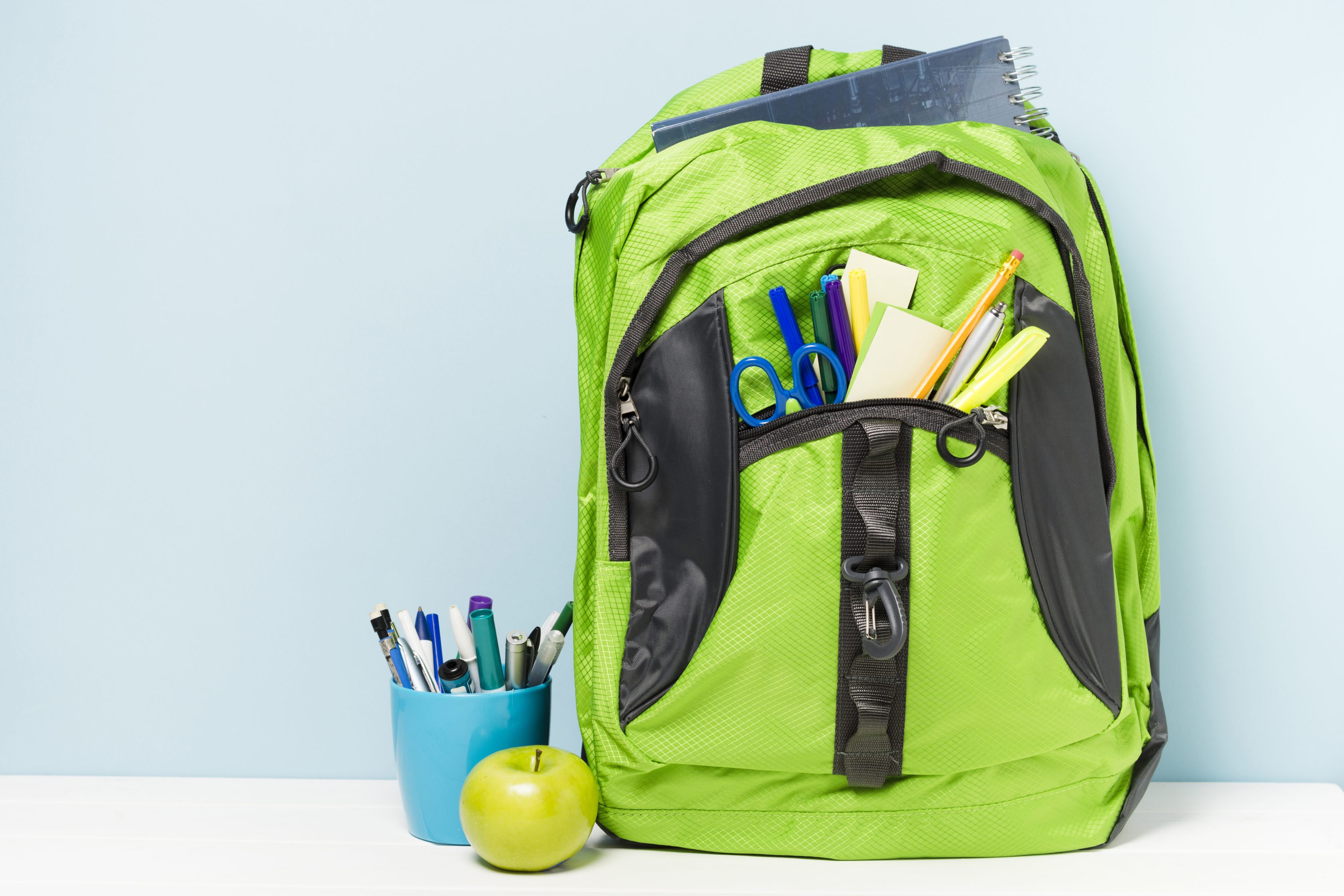 green-backpack-with-school-accessories